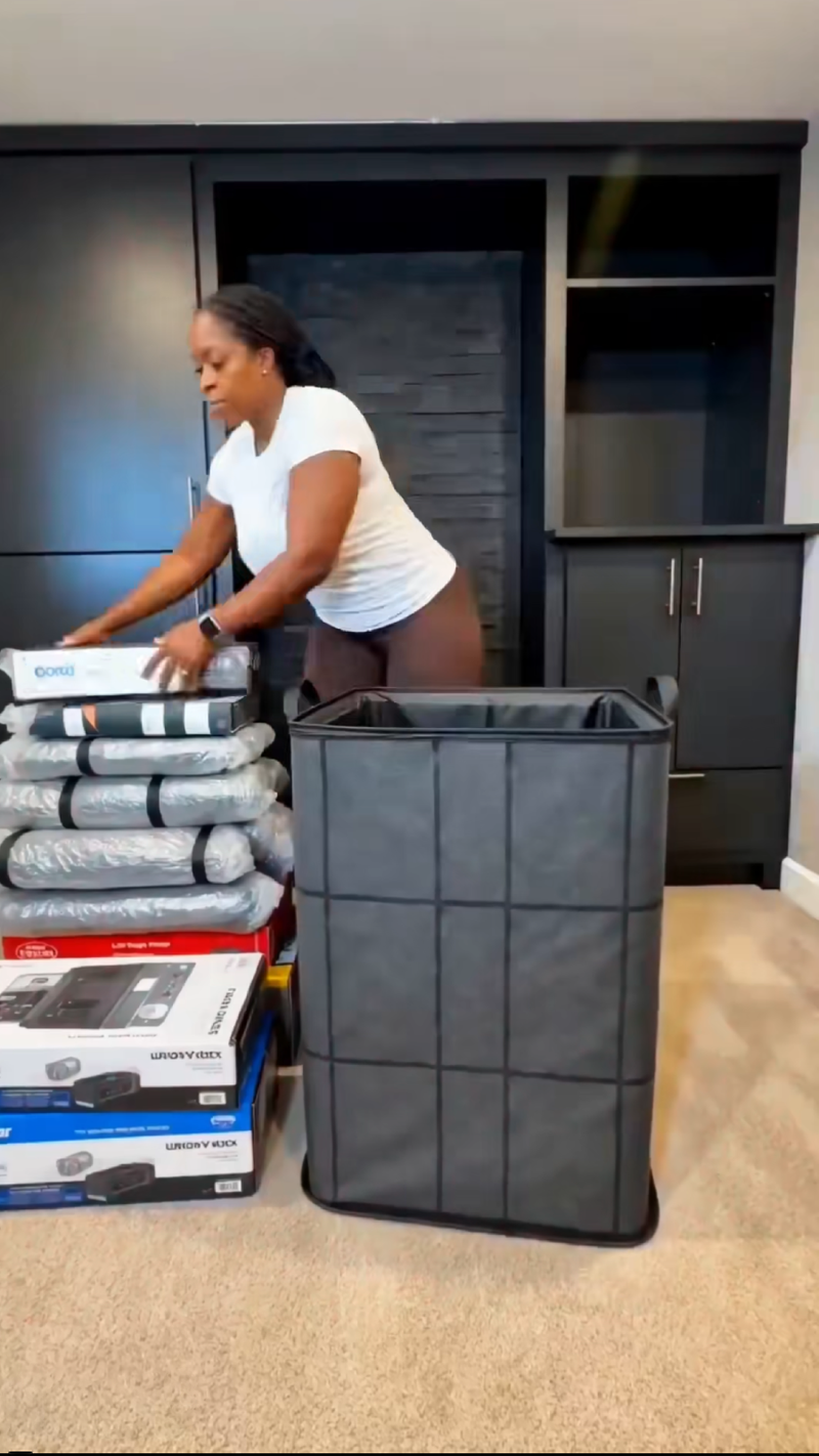Storage bag beside folded clothes and household supplies